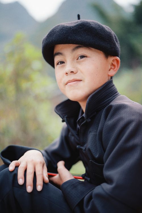 Free Charming portrait of a young boy wearing traditional attire in Hà Giang, Vietnam. Stock Photo