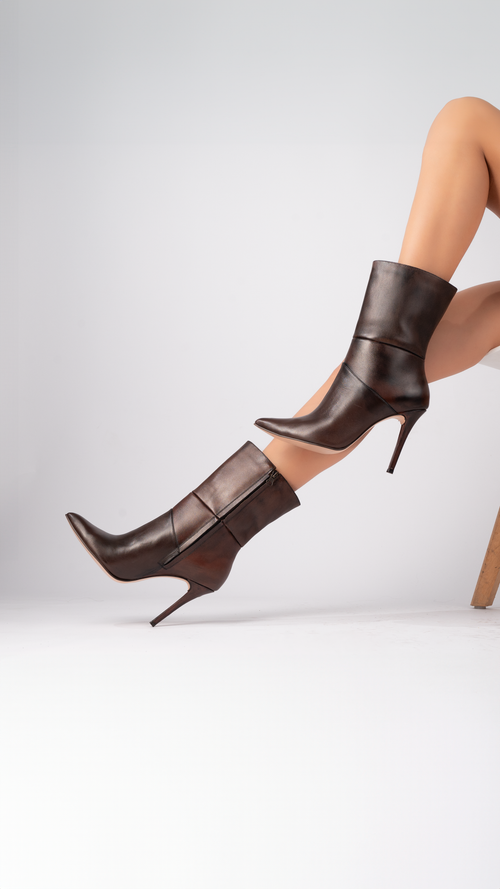 Free Stylish brown leather high heel boots showcased in a modern fashion photography setup. Stock Photo