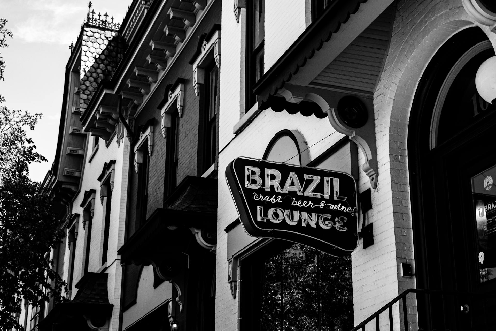 Black and white photo of the Brazil Lounge sign on a historic street in Jamestown, NY.