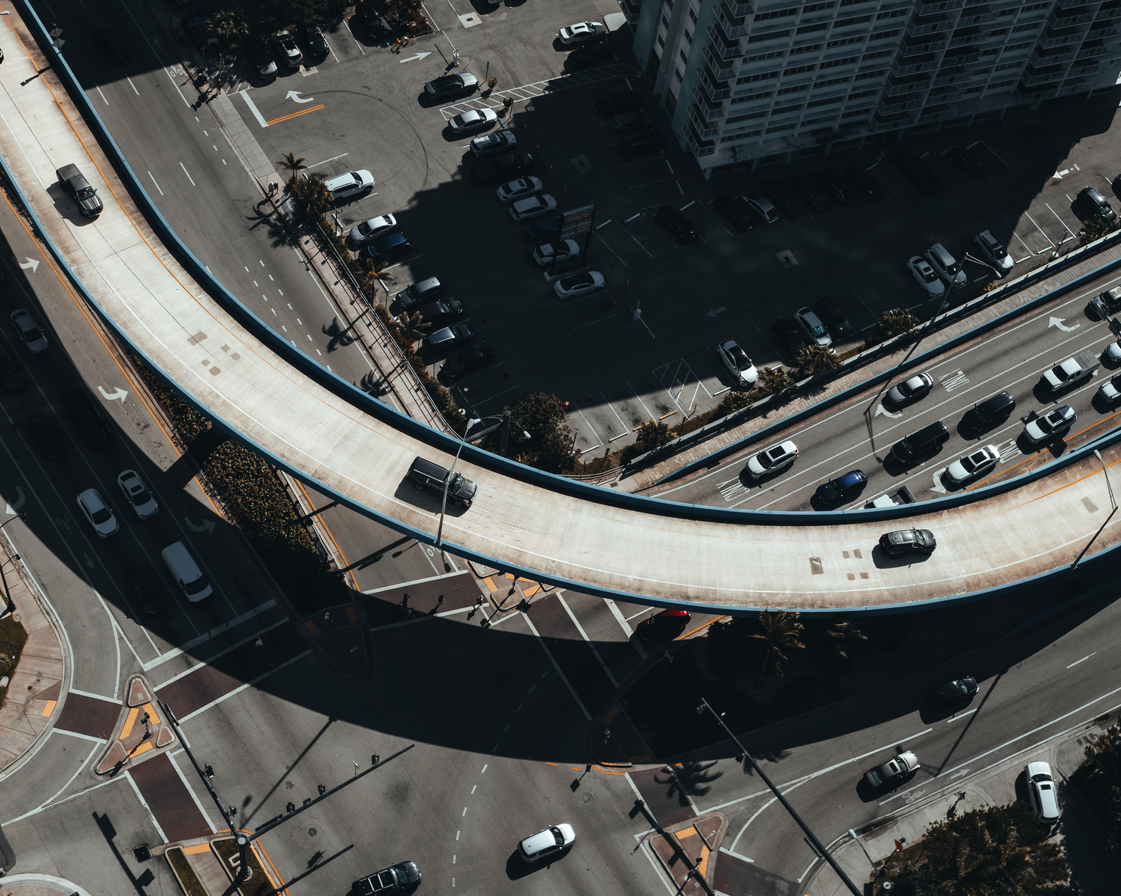 Aerial view showcasing a bustling urban elevated road intersection with busy traffic.