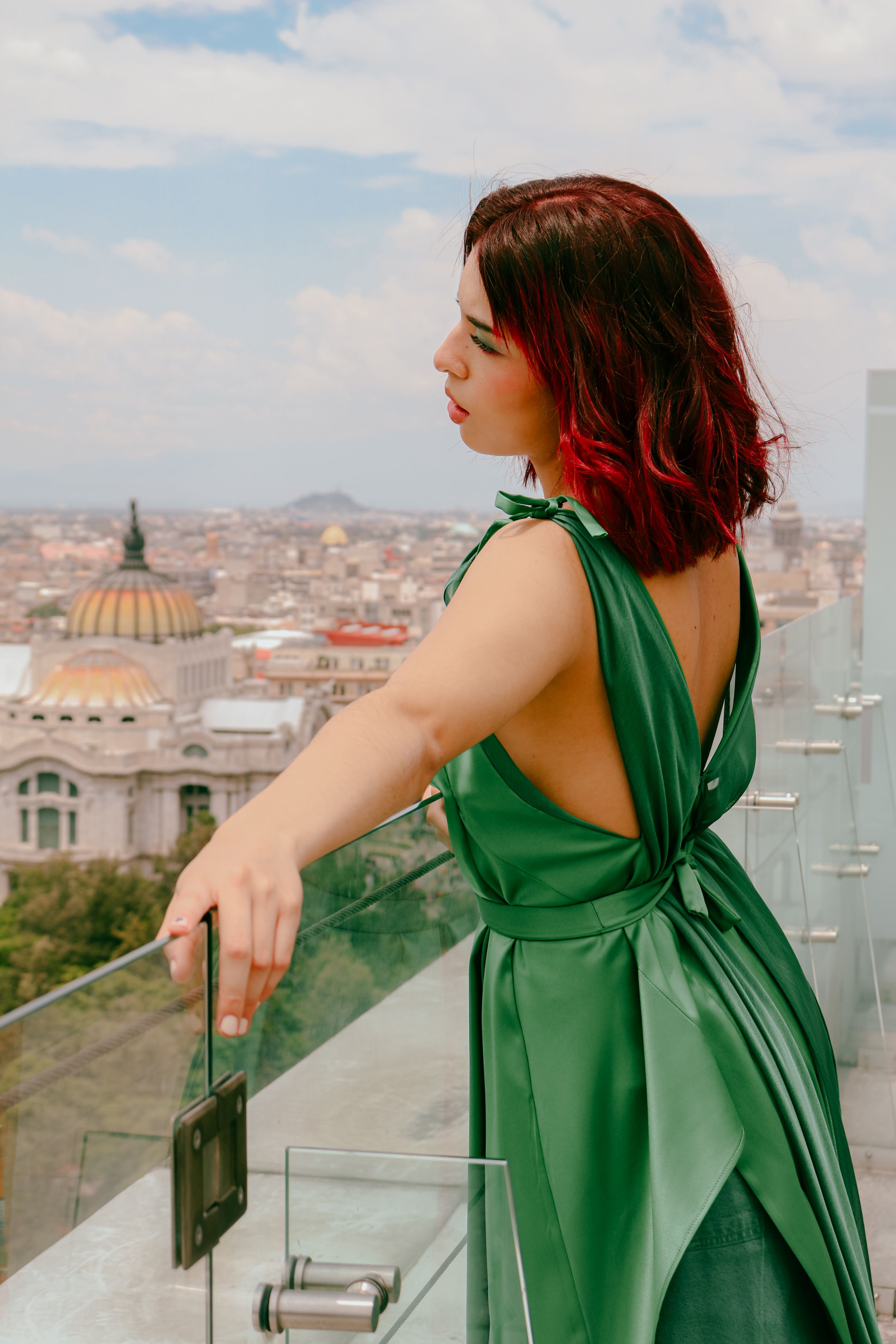 Model in Green Backless Dress Standing on Balcony  Free Stock Photo