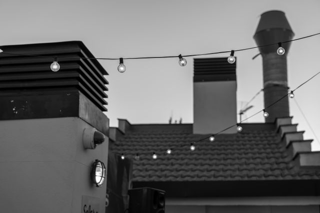 String lights strung between rooftops — photo by Nano Erdozain on Pexels