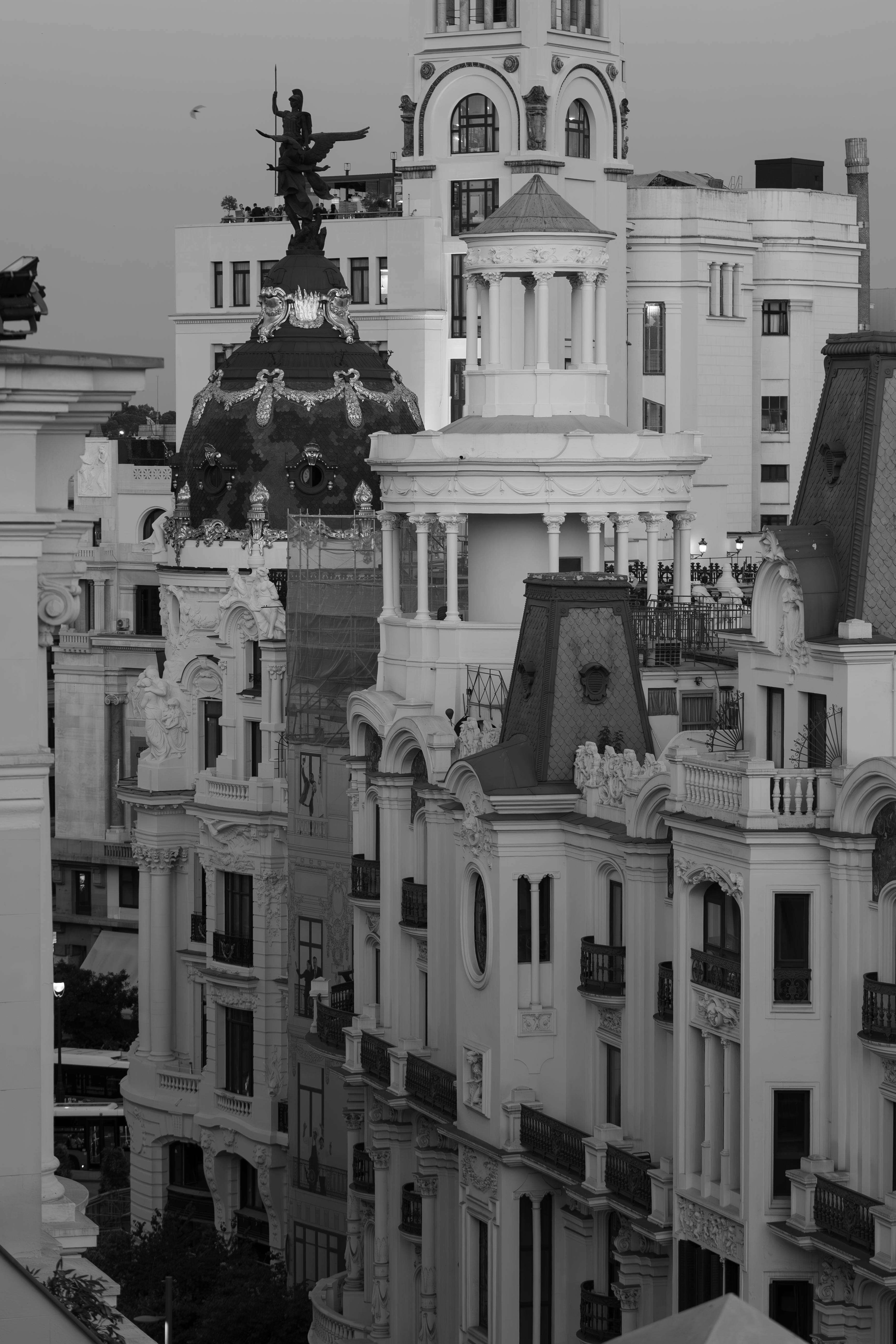 a black and white photo of a city with a clock tower