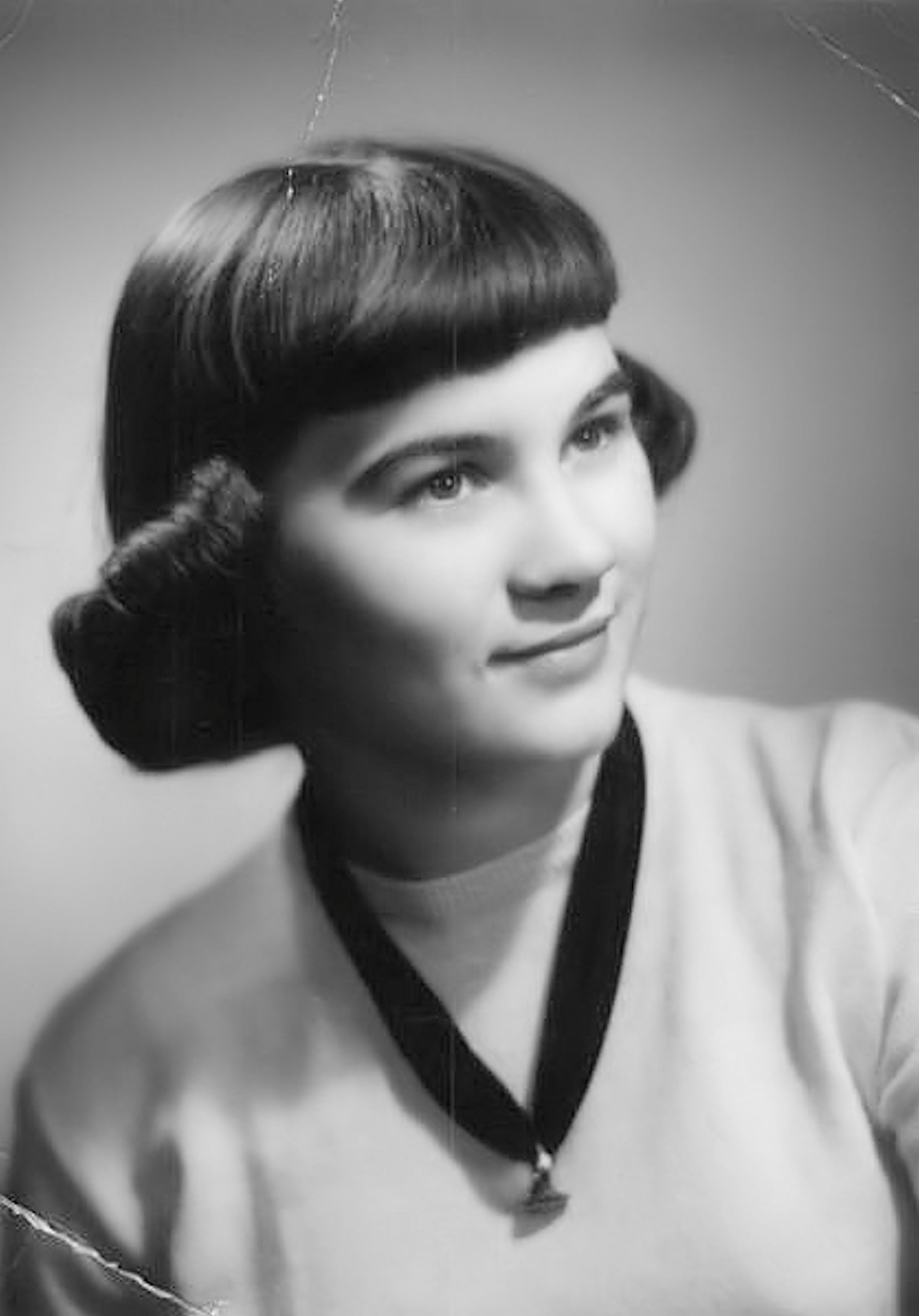 Classic black and white portrait of a woman in a vintage style with a necklace.