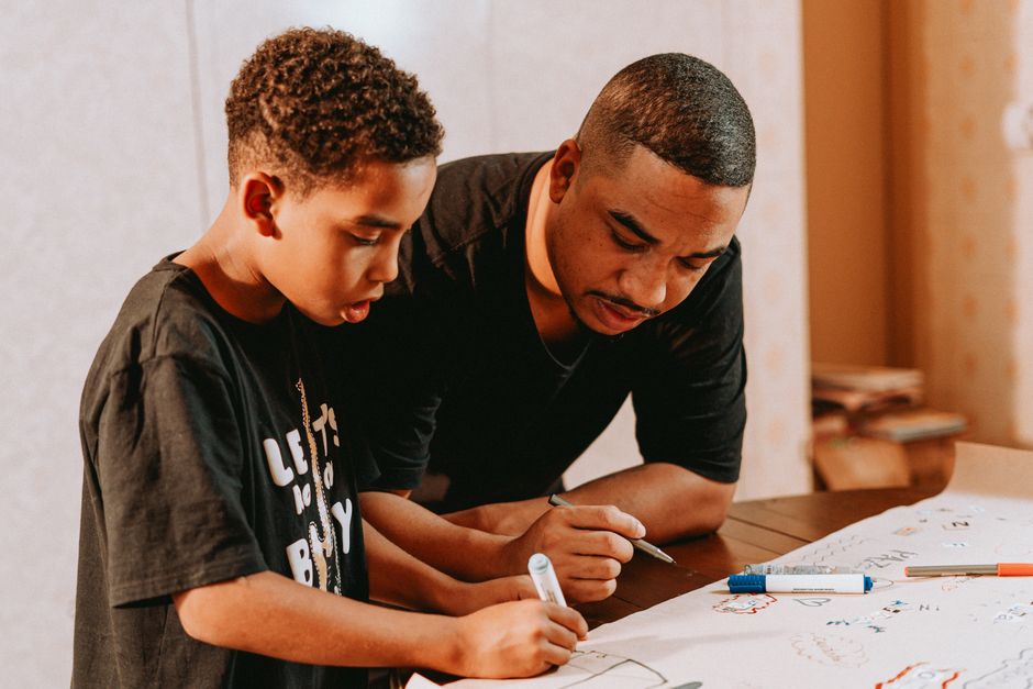 Boca Raton Rallies to Support the Education of a Son After a Father’s Tragic Death 2 Father and son bonding over drawing indoors, fostering creativity and learning. | BocaVibe