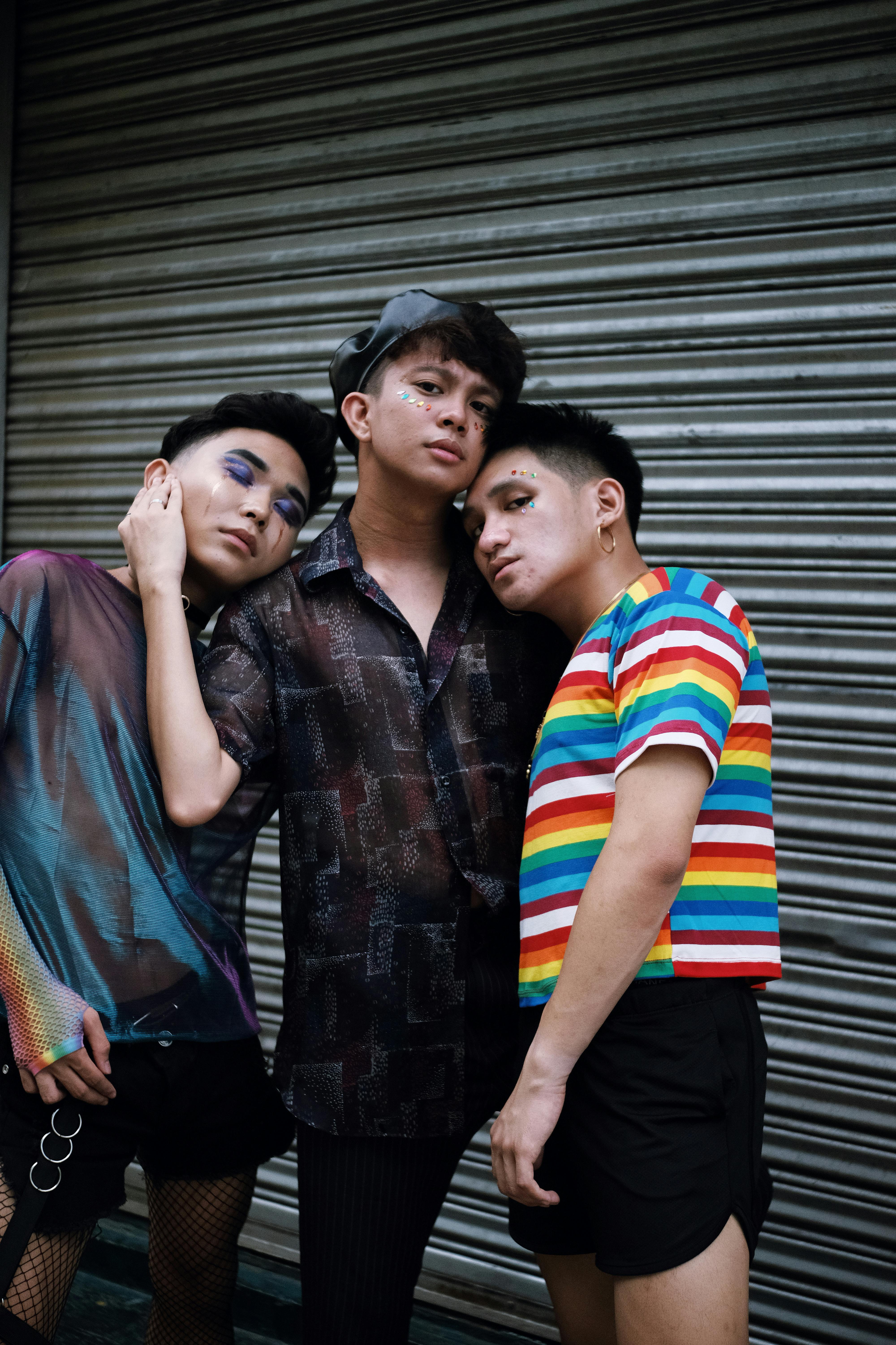 three men standing beside shutter door