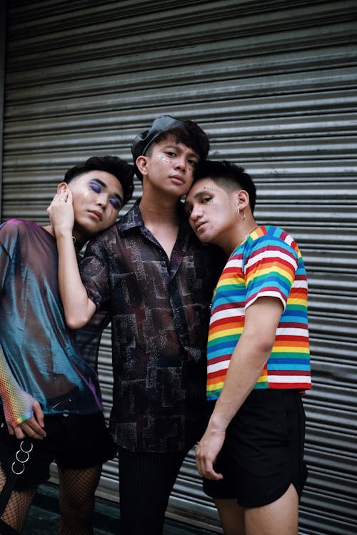 Three Men Standing Beside Shutter Door