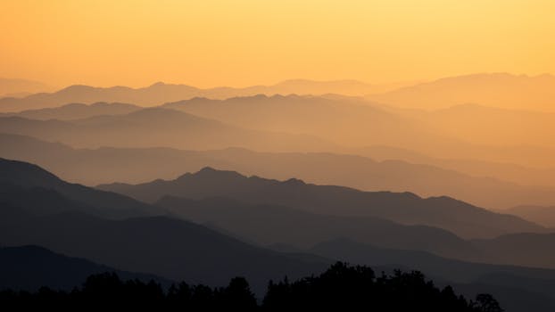 Captivating view of misty mountain layers at sunrise in Taiwan.