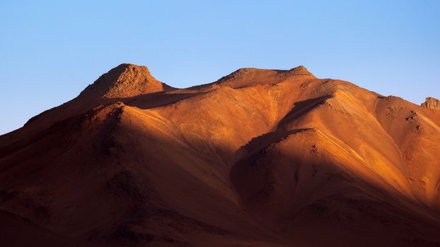 Majestic sand dunes under the golden light in the Atacama Desert, Chile, captured at sunrise.