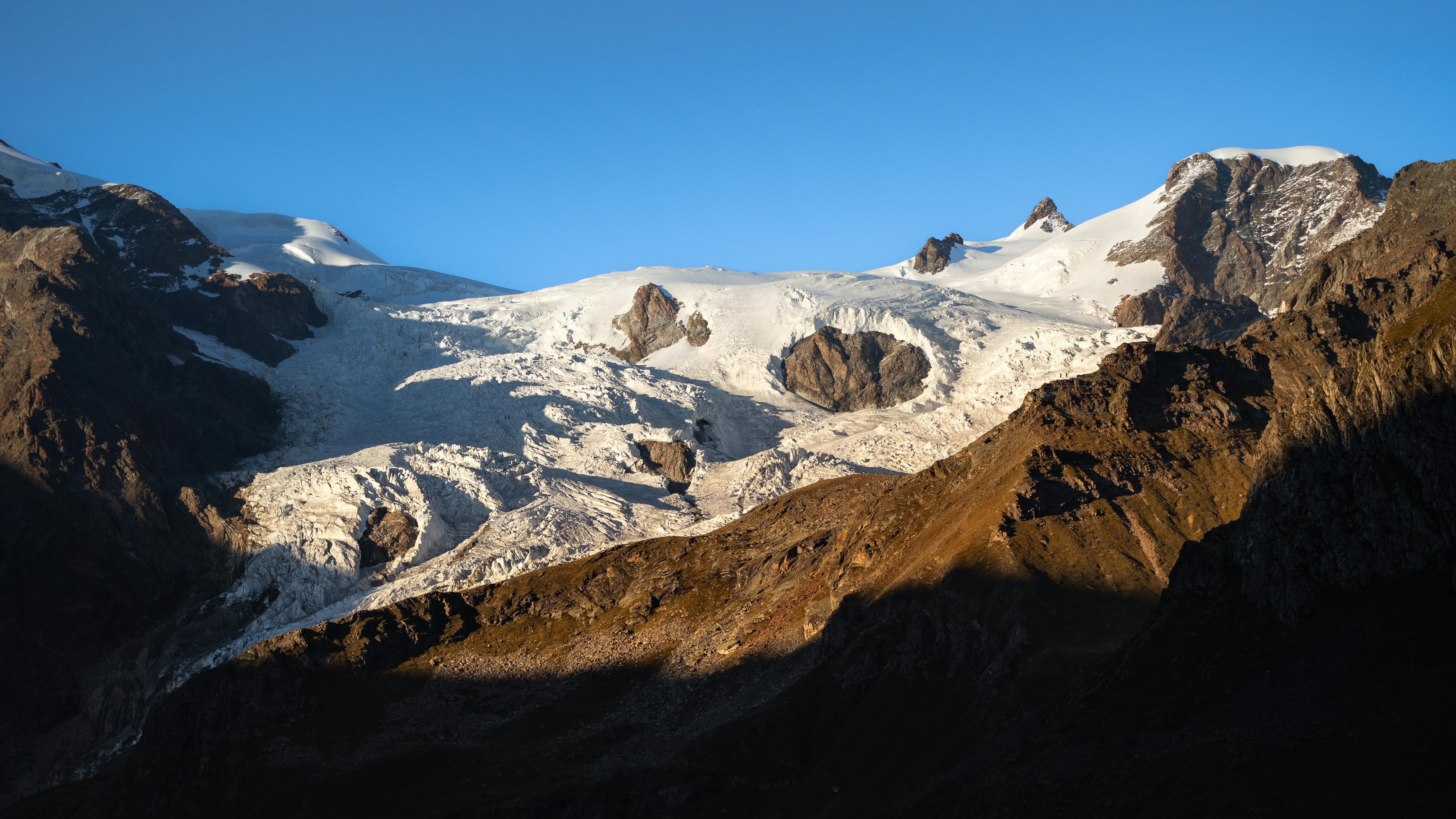 a large mountain with snow and ice on it