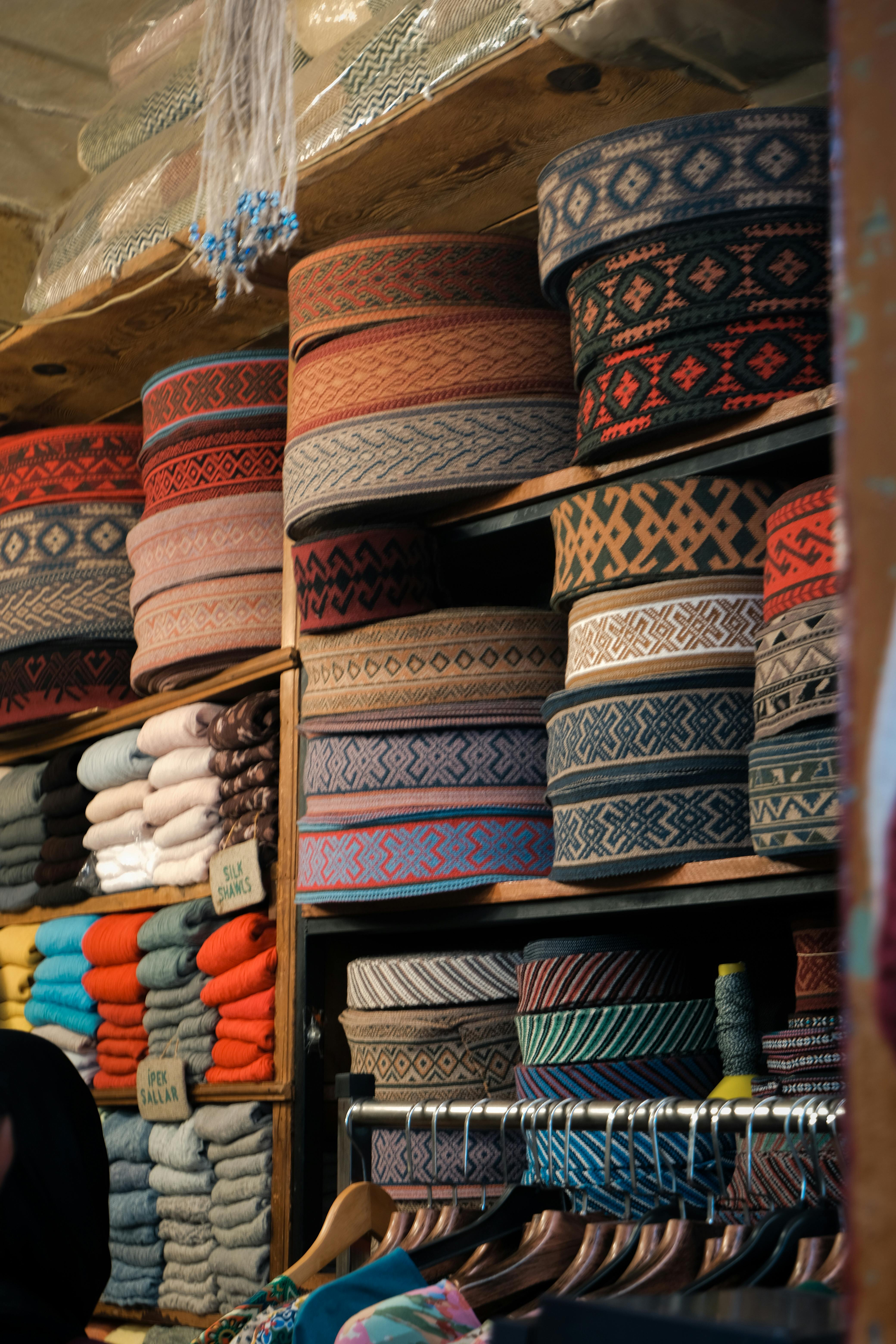 a man is looking at a rack of colorful ties