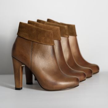 Brown leather ankle boots lined up on a pale surface — José Martin Segura Benites on Pexels