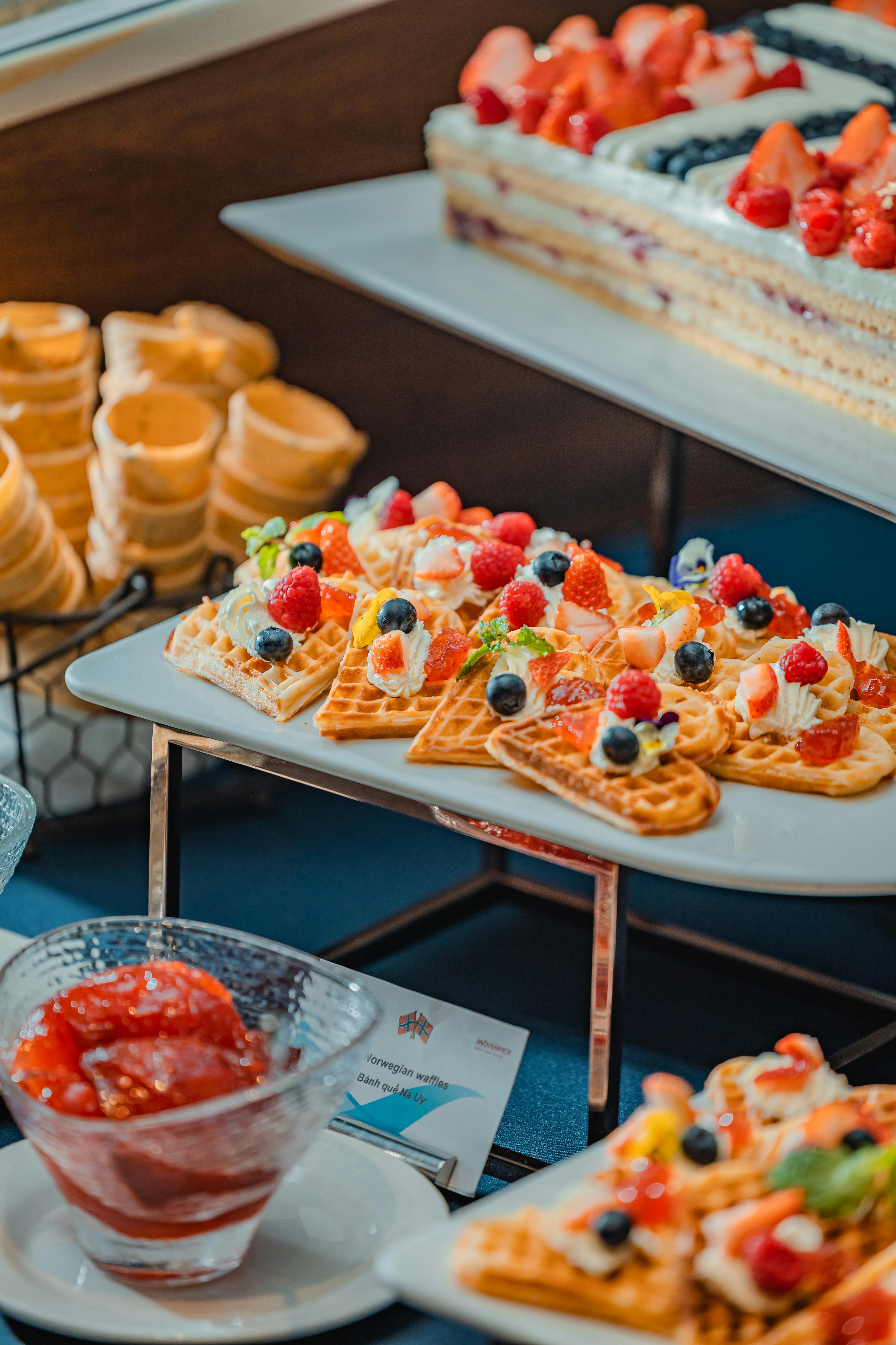 waffles with cream and fruits on tables