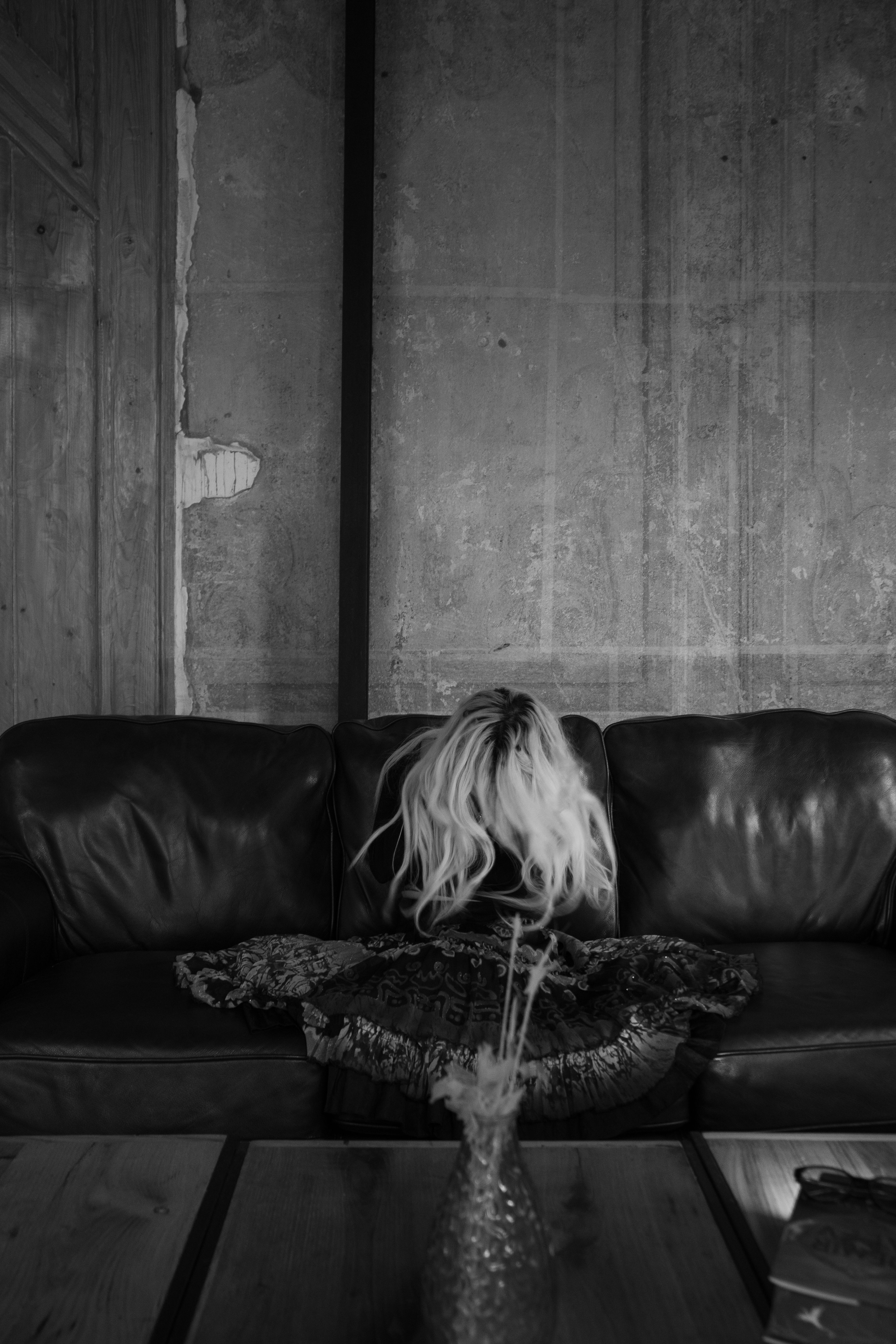 A woman sitting on a couch in a room · Free Stock Photo