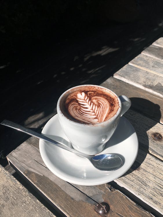 Free A Cup of Cappuccino on Wooden Table Stock Photo