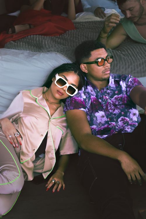 Free Stylish couple wearing sunglasses enjoying a relaxed indoor party vibe. Stock Photo