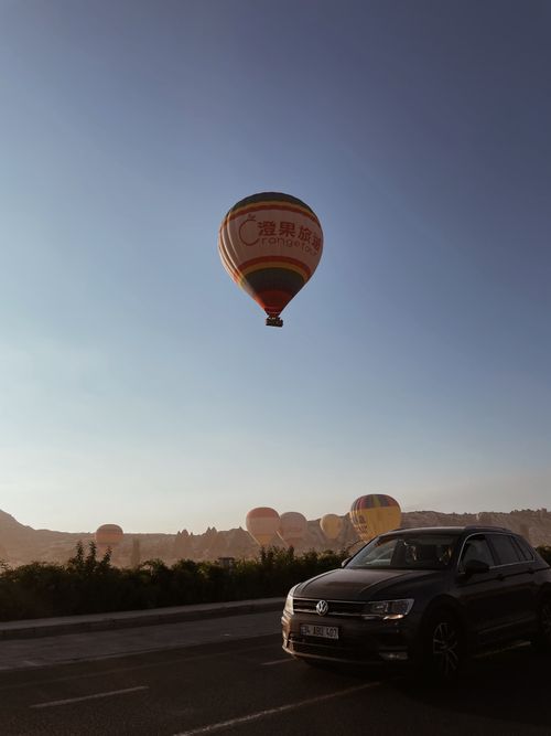 Free Experience the serene beauty of Cappadocia with hot air balloons floating at sunset. Stock Photo