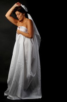 An elegant, contemporary bride captured in a glamorous portrait, embracing sophistication and style.