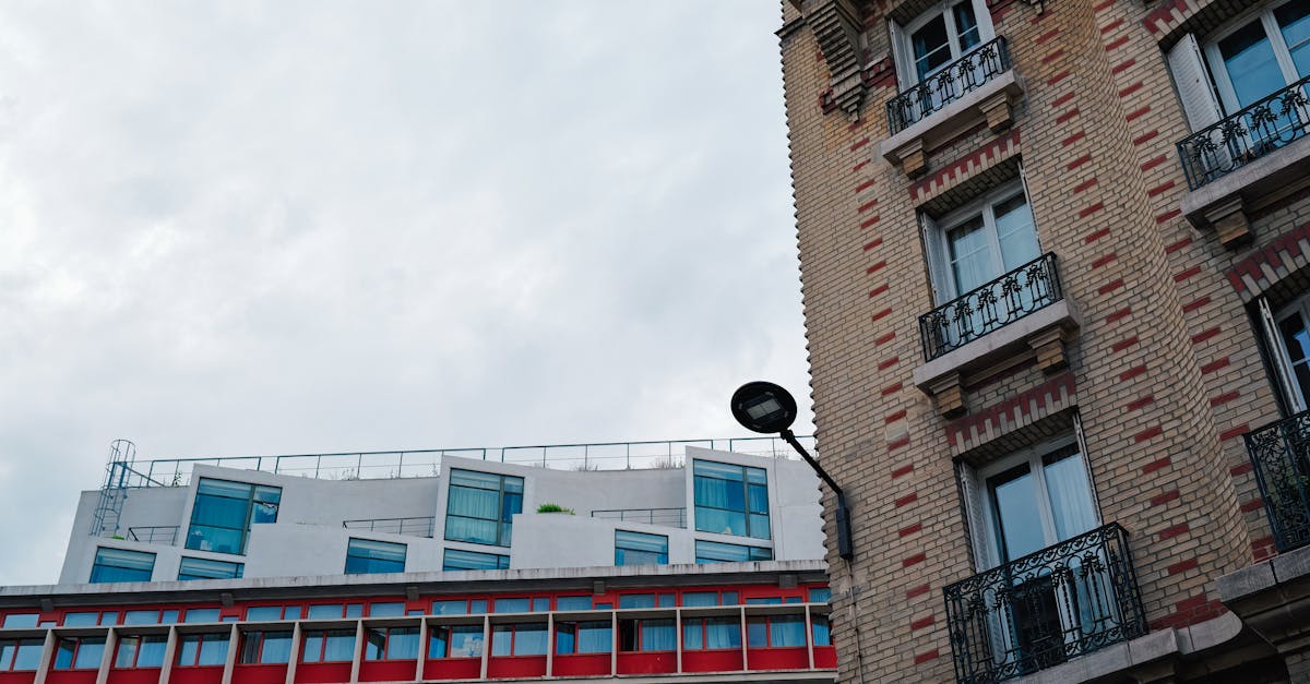 Photo by Adrien Olichon Vibrant city buildings showcasing modern urban architecture with colorful facade and classic elements.