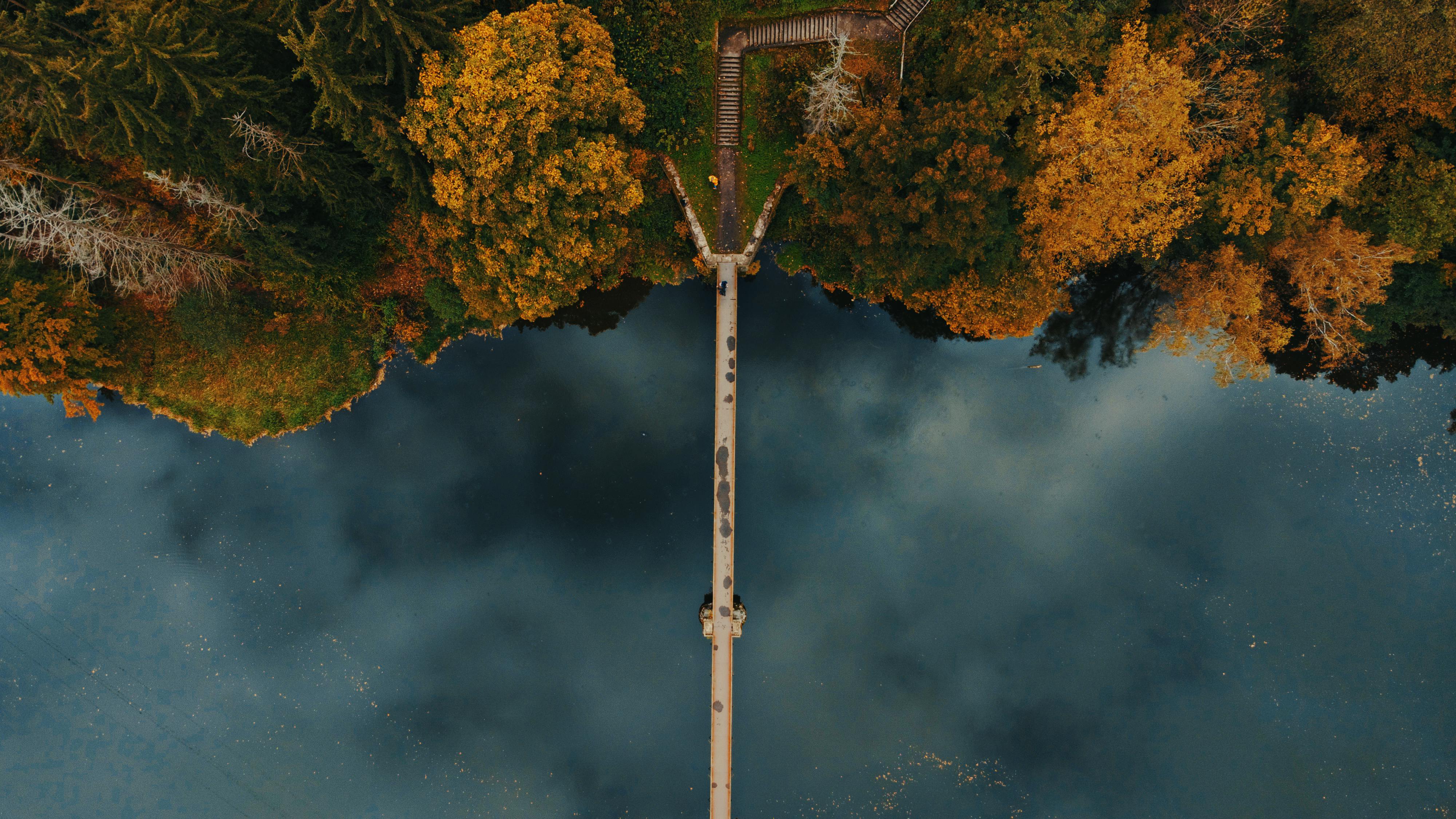 an aerial view of a bridge over a lake