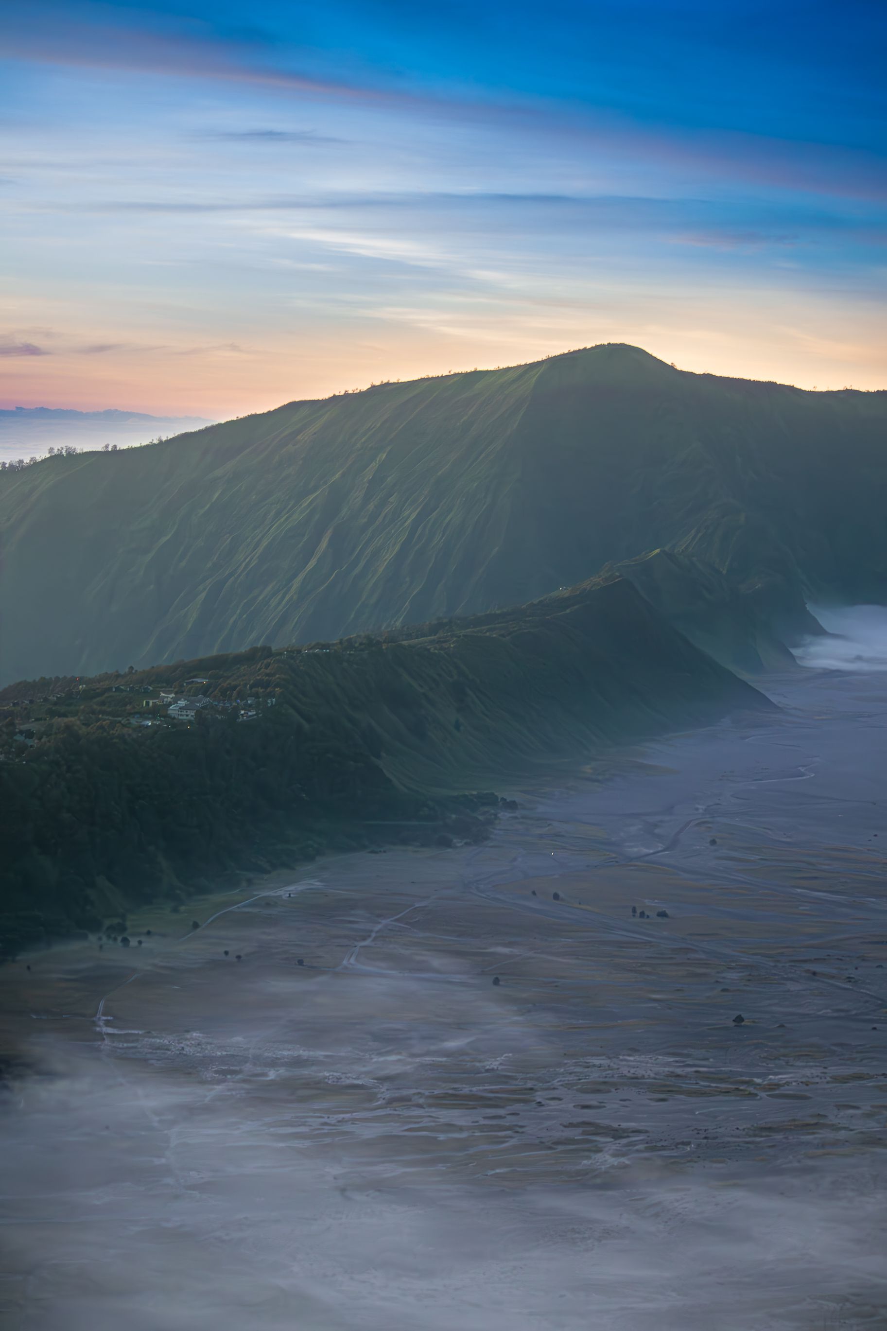 Aerial View of Waves Washing Up the Beach of an Island with Mountains