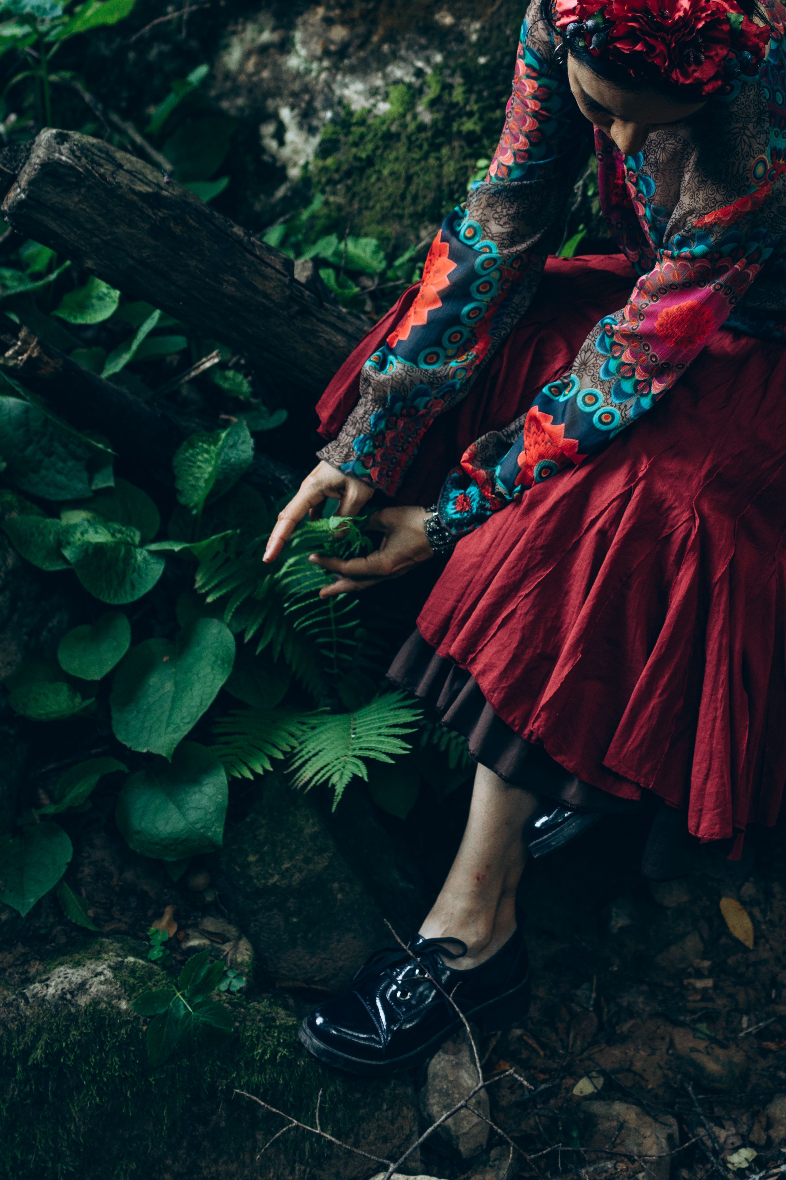 A woman in a red dress and black shoes is sitting on the ground · Free ...