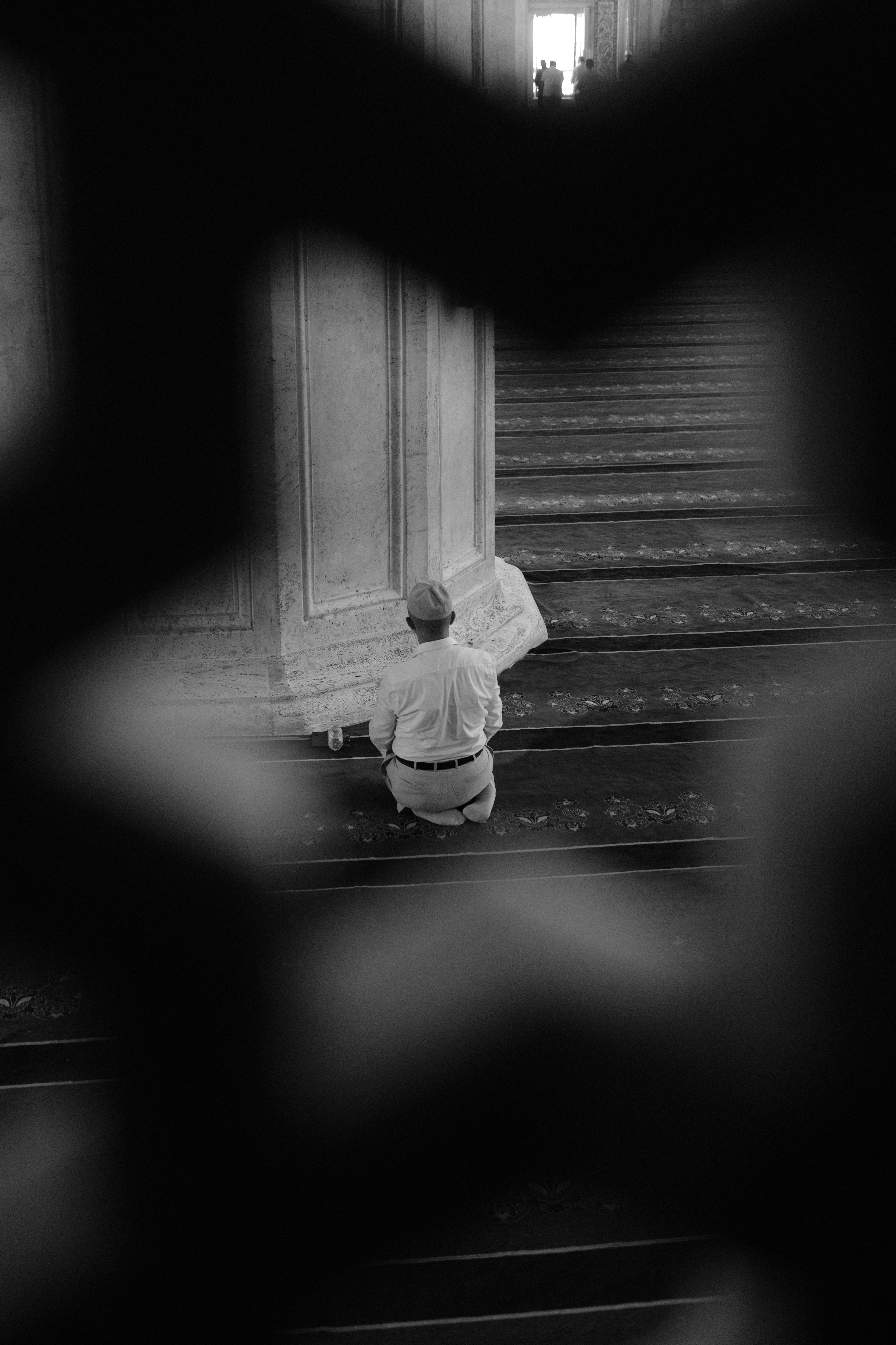 a man sitting on the steps of a building reading a newspaper