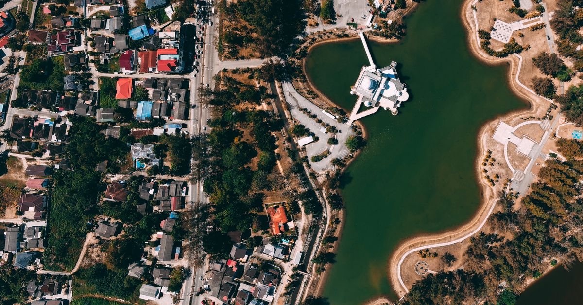 An aerial photo showcasing a vibrant urban landscape adjacent to a serene lake.