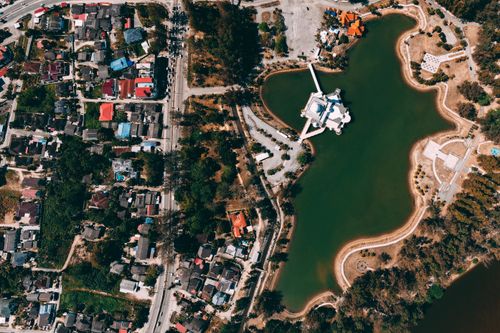Free An aerial photo showcasing a vibrant urban landscape adjacent to a serene lake. Stock Photo