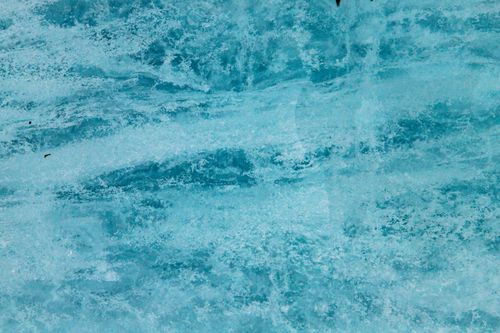Free A vivid close-up of a blue glacier surface with intricate ice textures showcasing nature's beauty. Stock Photo