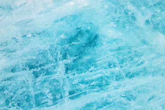A close-up of pristine blue ice showcasing its natural crystalline texture and chilly ambiance.