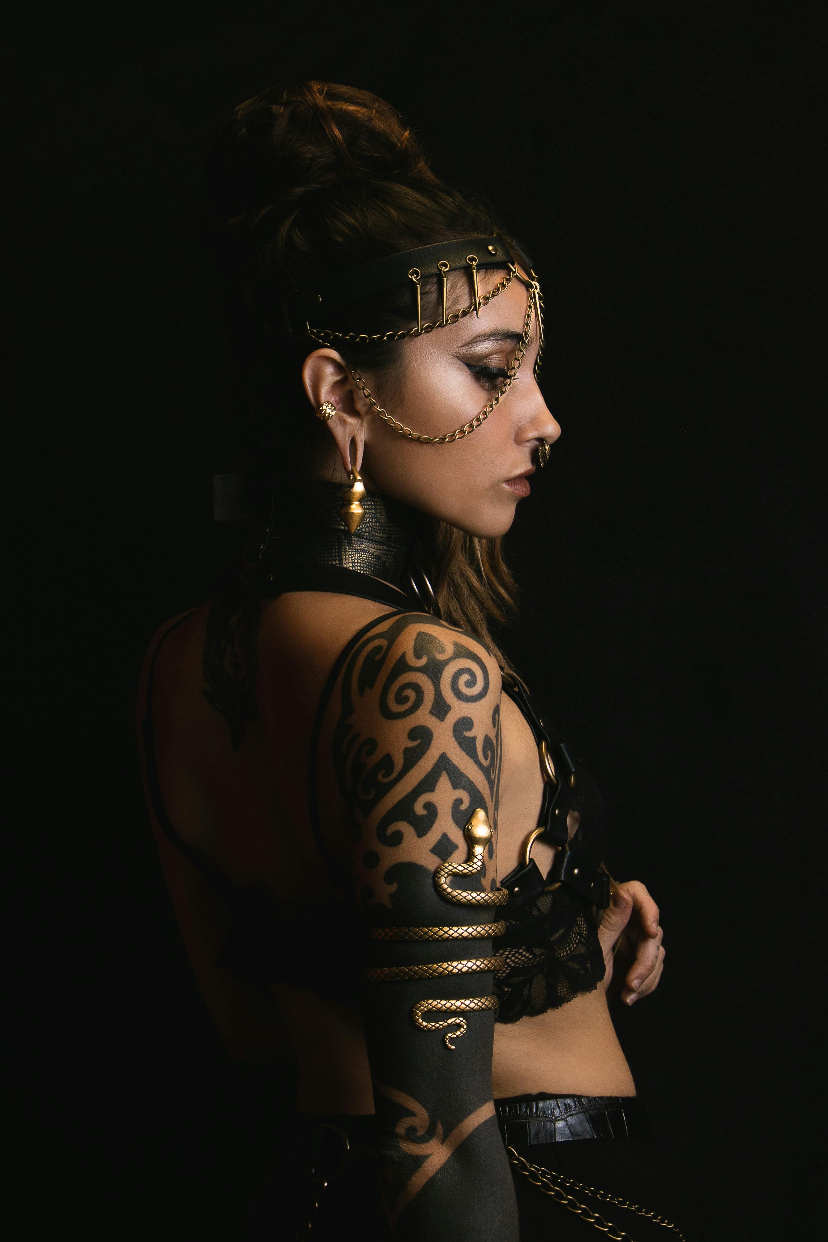 Portrait of a young woman with intricate tattoos and fashion accessories, exuding glamour and style.