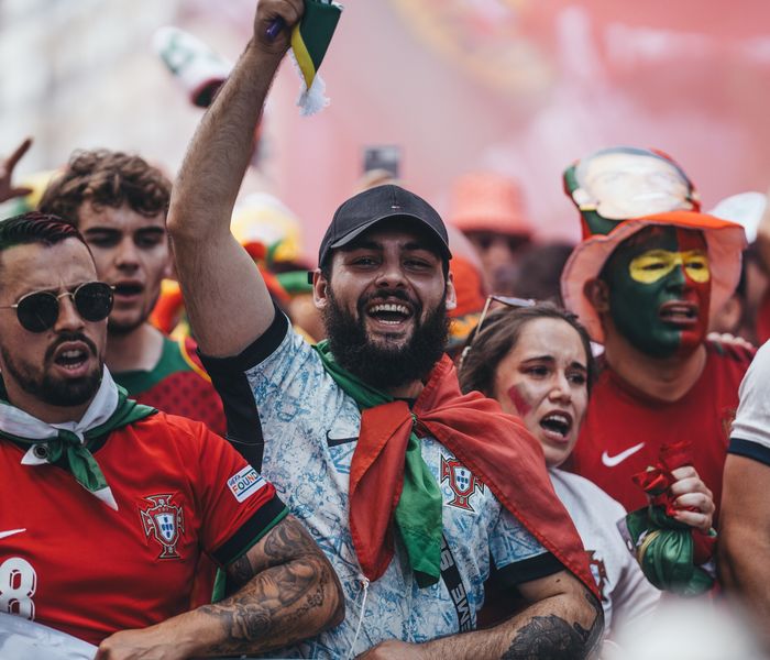Group of Portuguese football fans celebrating outdoors