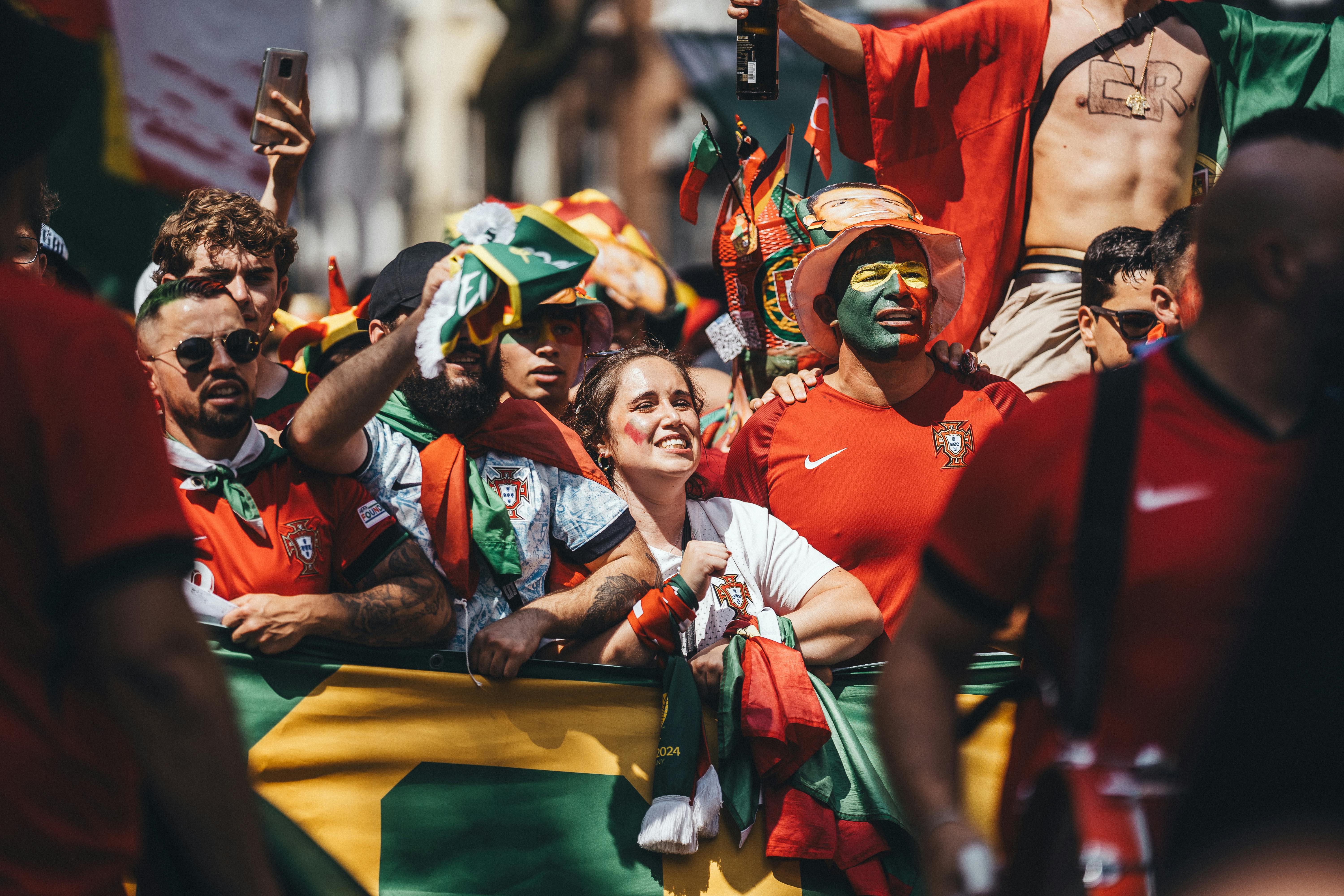 a group of people with flags and red and green