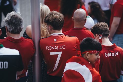 Free Football enthusiasts gather in team jerseys, celebrating their passion for the game outdoors. Stock Photo