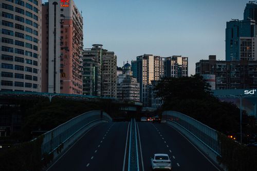 Free Twilight view of a bustling urban skyline in Xiamen, showcasing high-rise buildings and a highway. Stock Photo