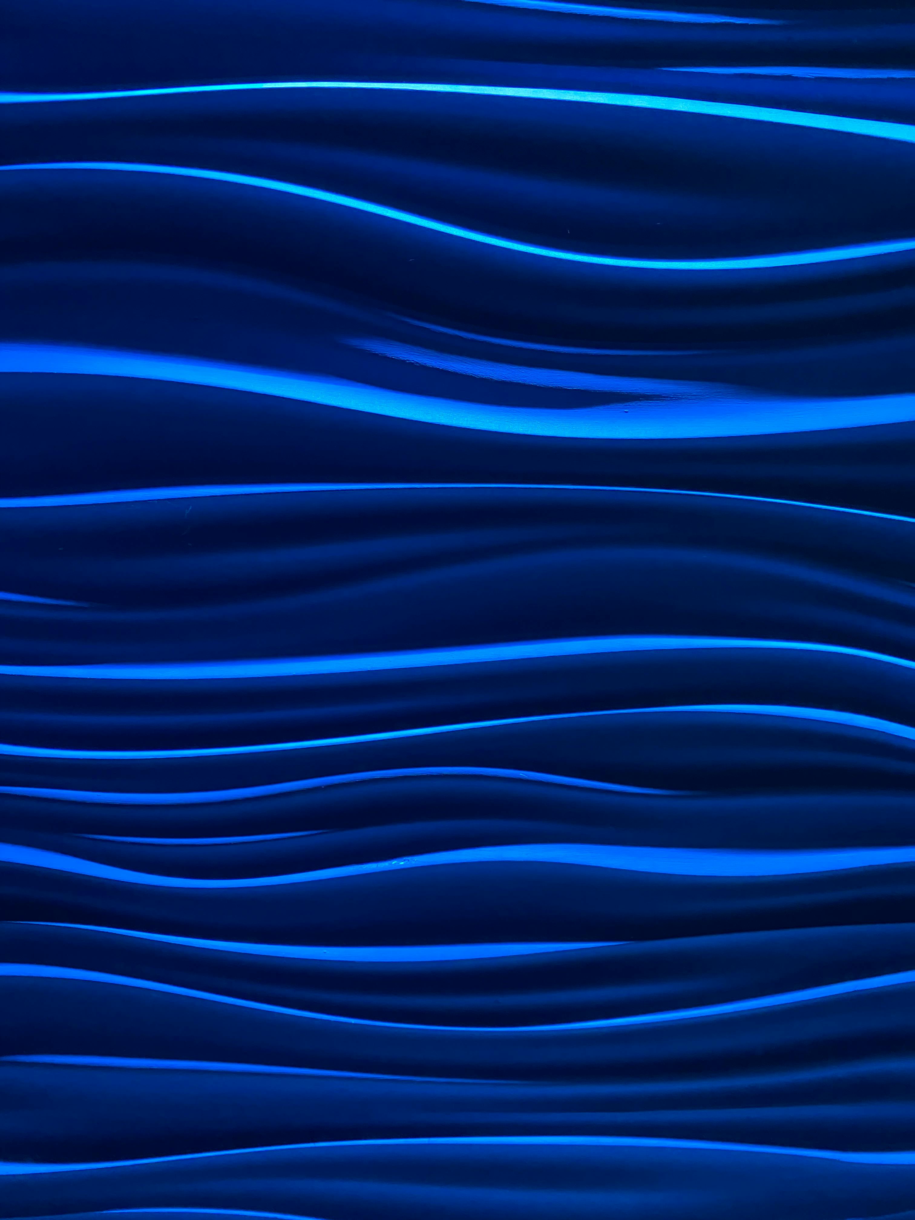 Abstract blue waves pattern with smooth texture and aesthetic flow.
