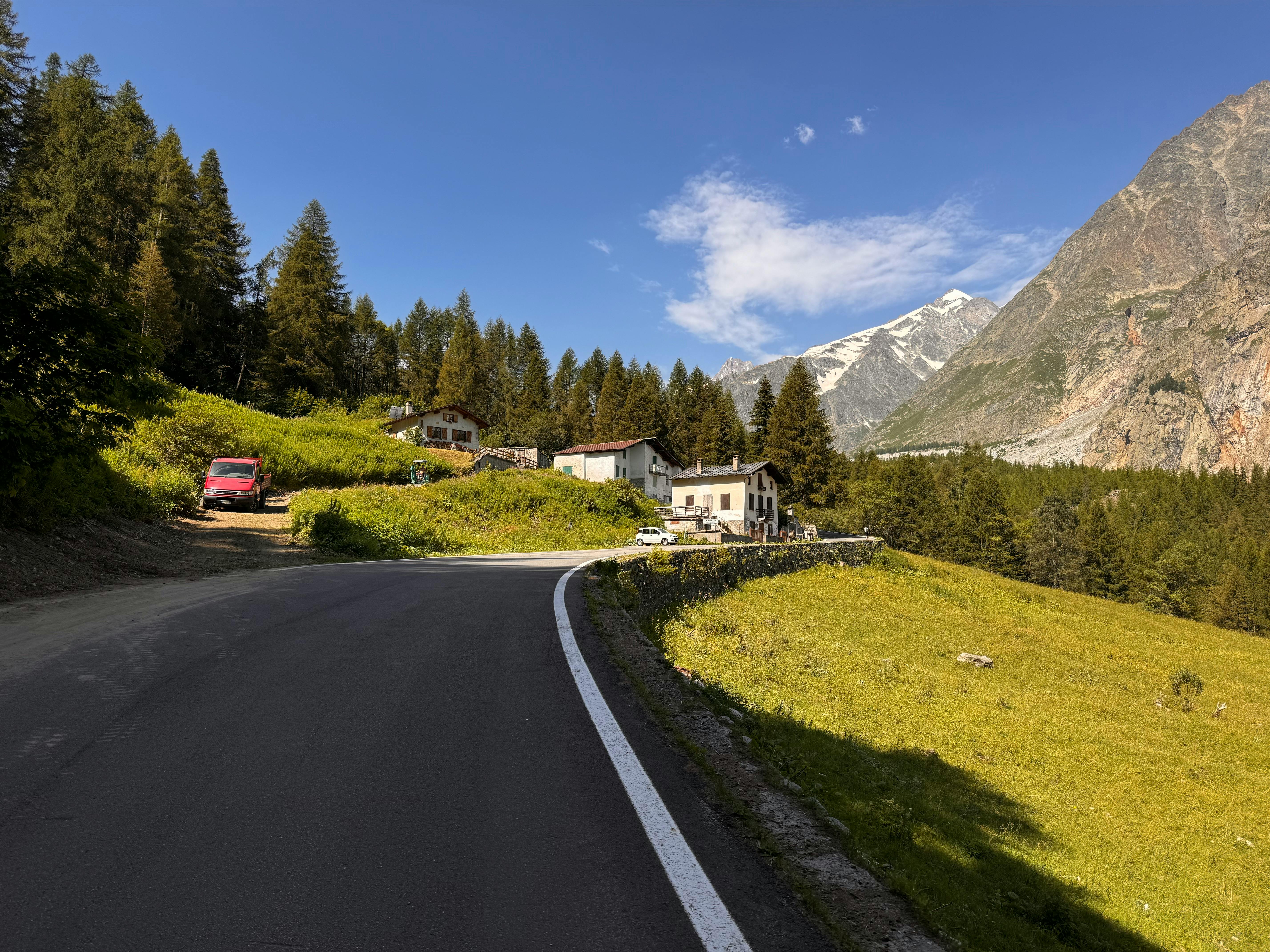 a road in the mountains with a mountain in the background