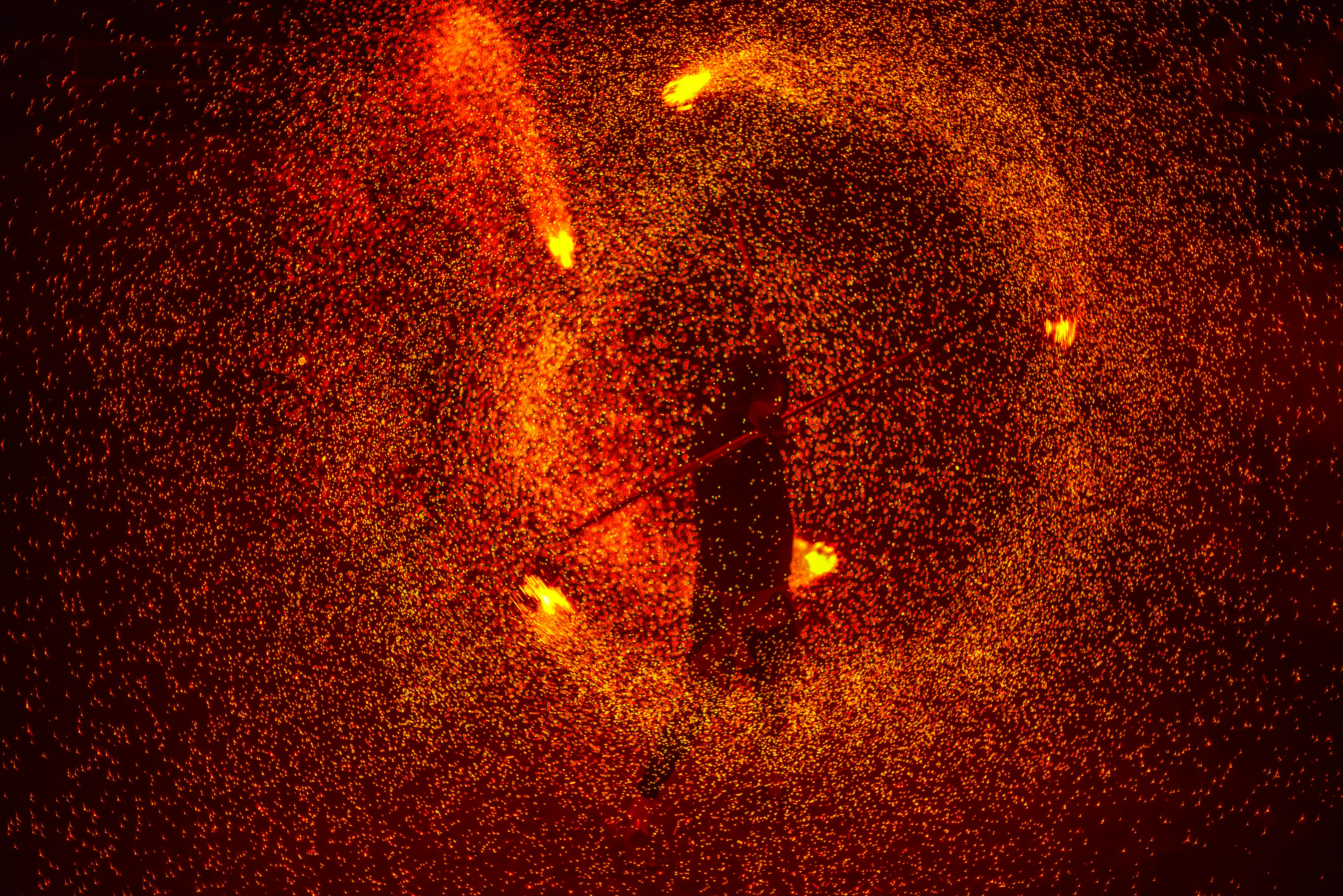 A mesmerizing fire dance captured with vibrant swirling sparks and dynamic motion.