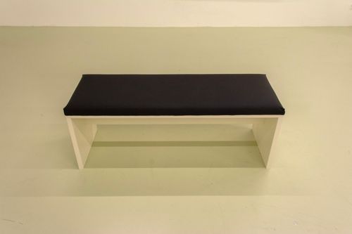 Free Simple wooden bench with black cushion in minimalist setting Stock Photo
