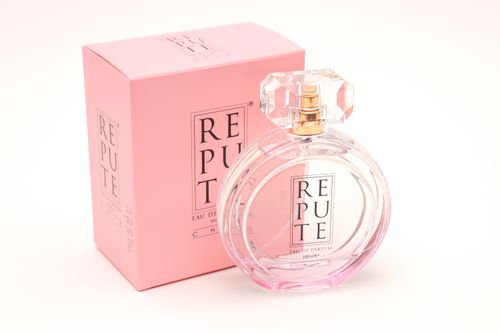 Free A stylish perfume bottle with pink box displaying elegant fragrance branding. Stock Photo