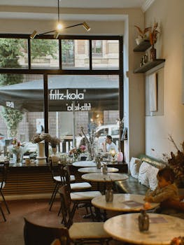 Warm and inviting cafe with people enjoying coffee and conversation.