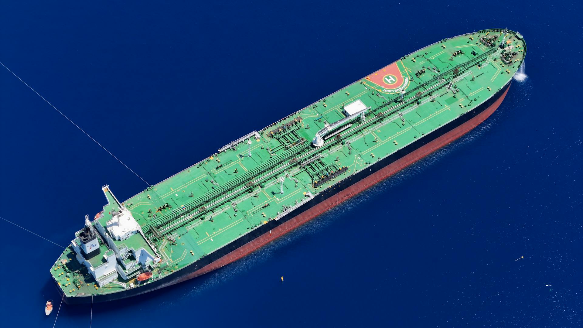 Aerial shot of an oil tanker sailing in the ocean near Vado Ligure, Italy.