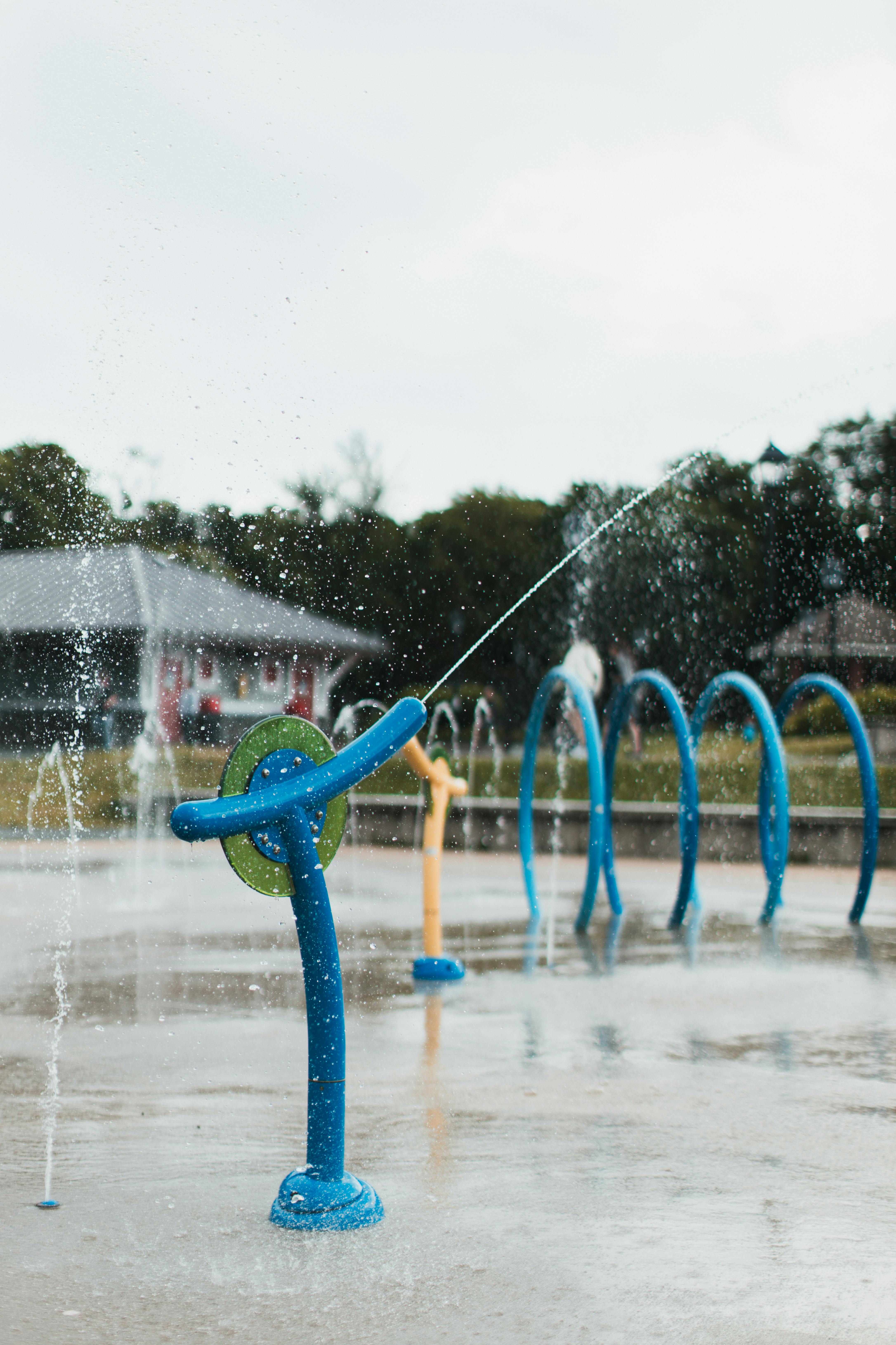 a water fountain with blue and yellow water jets