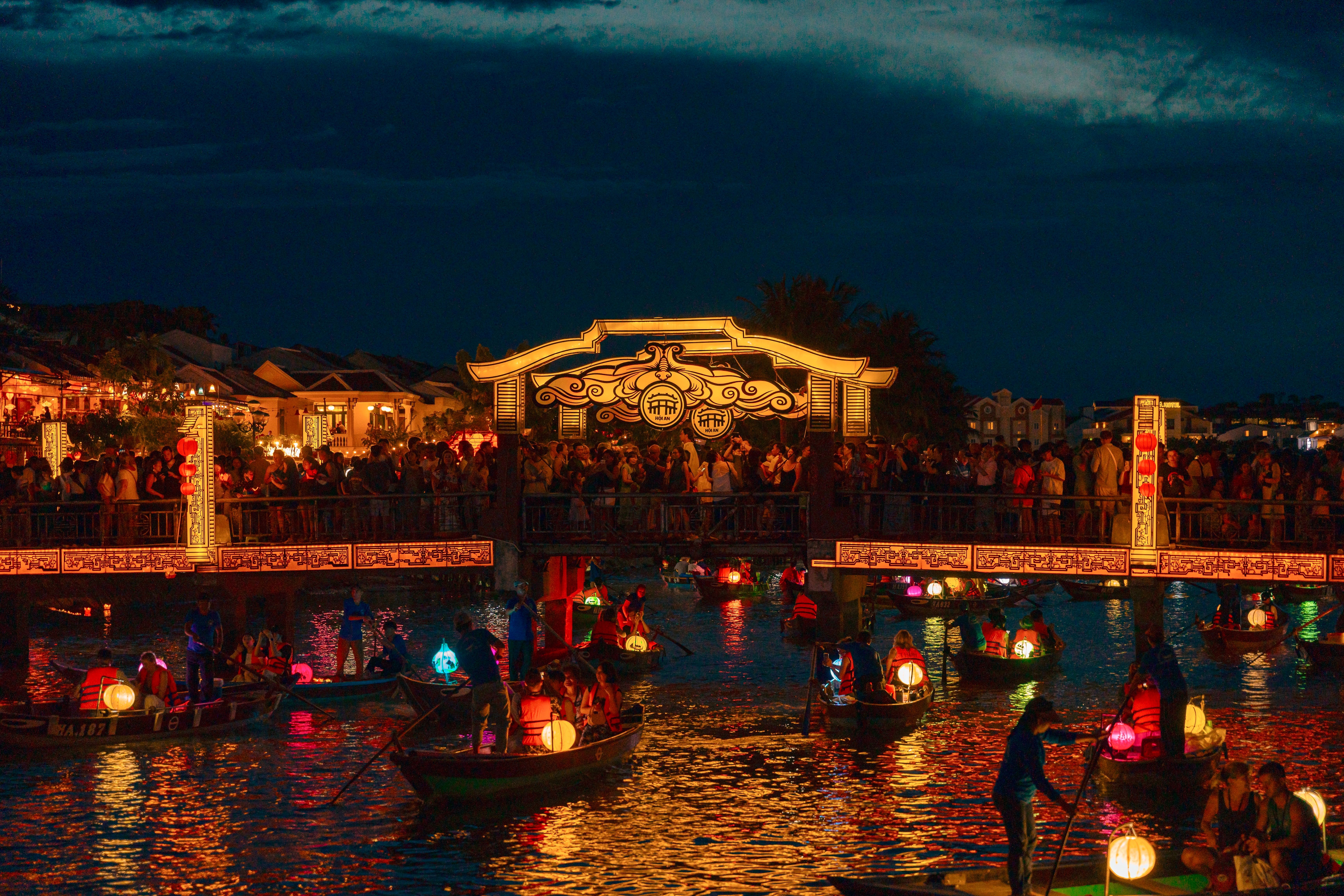 Silk lanterns lit above a street in the old town at Hoi An.