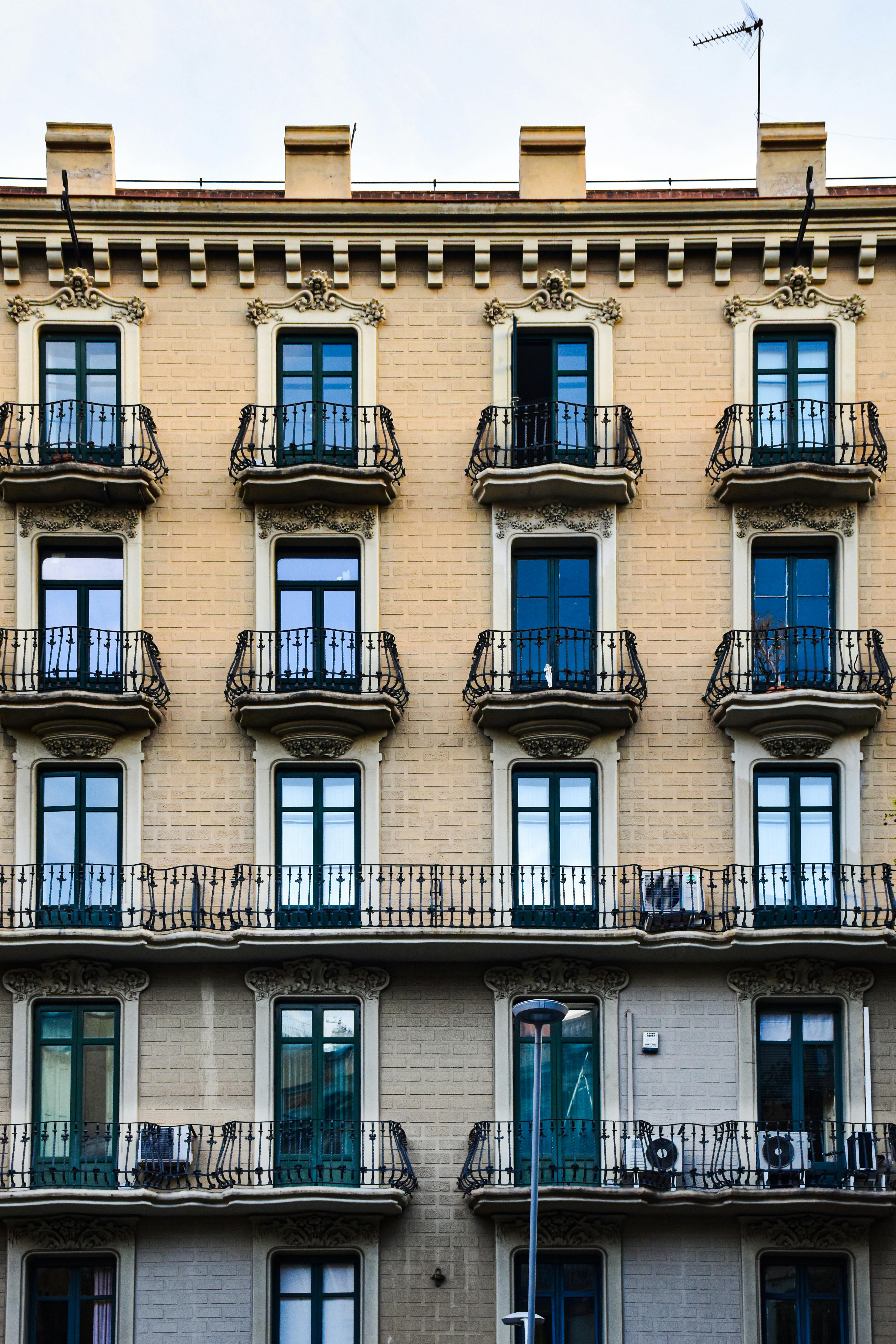 a building with balconies and windows on the side