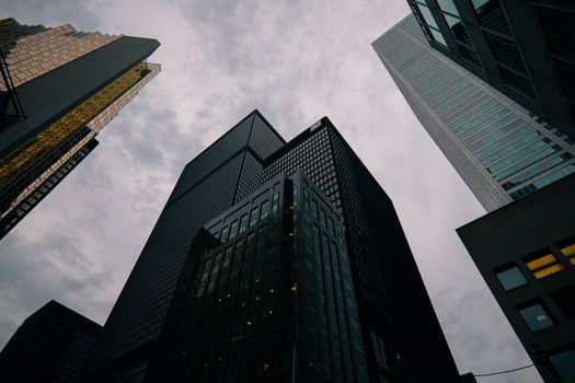 Toronto skyscrapers reaching into a cloudy sky, showcasing urban architecture.
