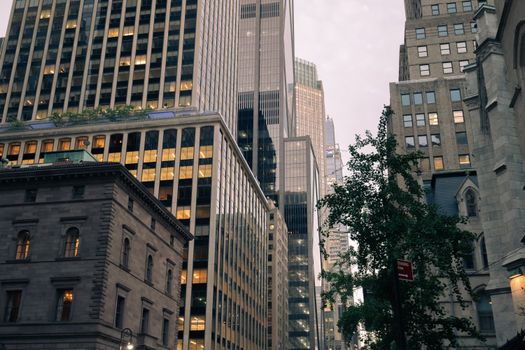 A modern New York City skyline featuring tall skyscrapers and urban architecture at dusk.