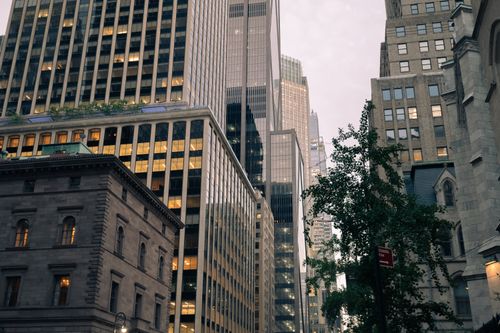 Free A modern New York City skyline featuring tall skyscrapers and urban architecture at dusk. Stock Photo