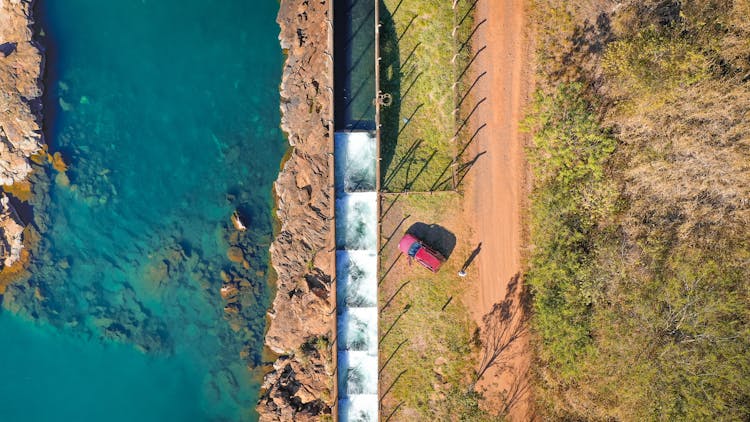 Top View Photo Of Person Standing Beside Vehicle